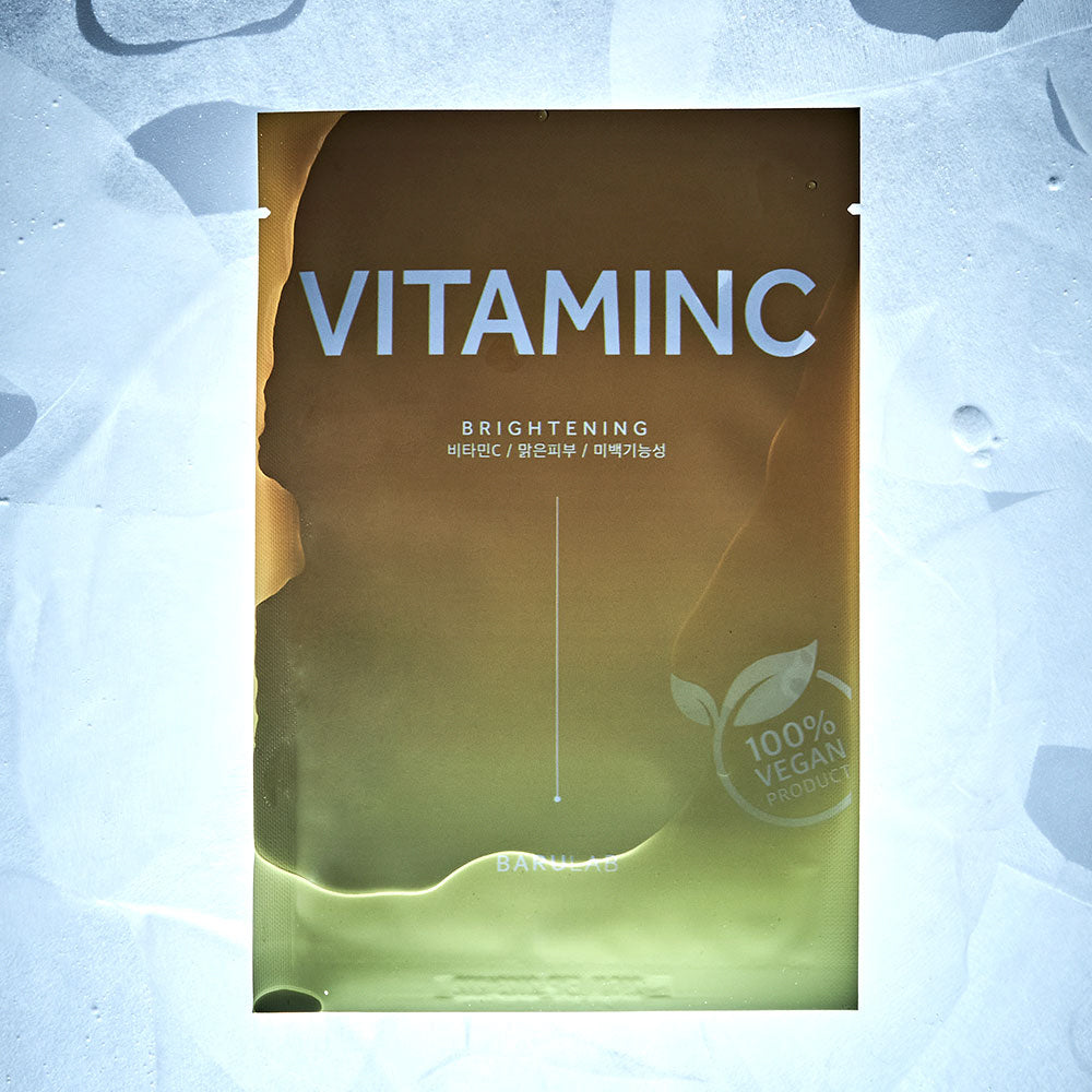 Single Barulab Clean Vegan Vitamin C Mask Sheet package surrounded by several sheet masks outside their packages.