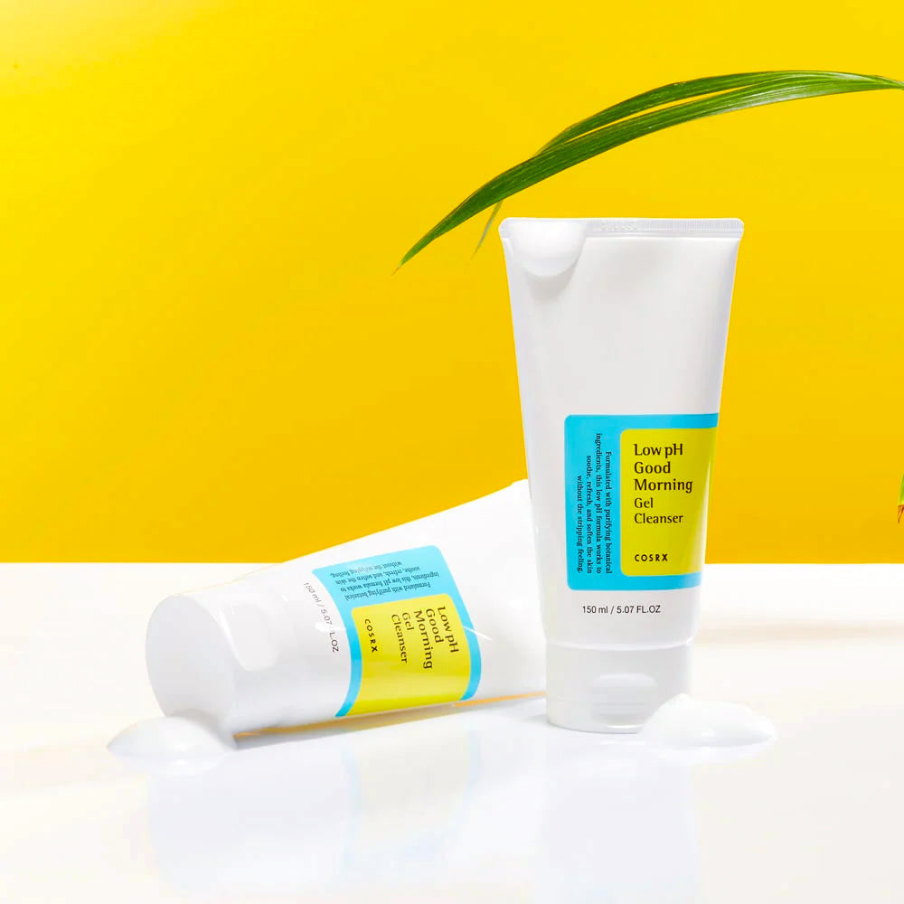 Two tubes of COSRX Low pH Good Morning Gel Cleanser against a yellow background, with some cleanser gel oozing from the tubes.